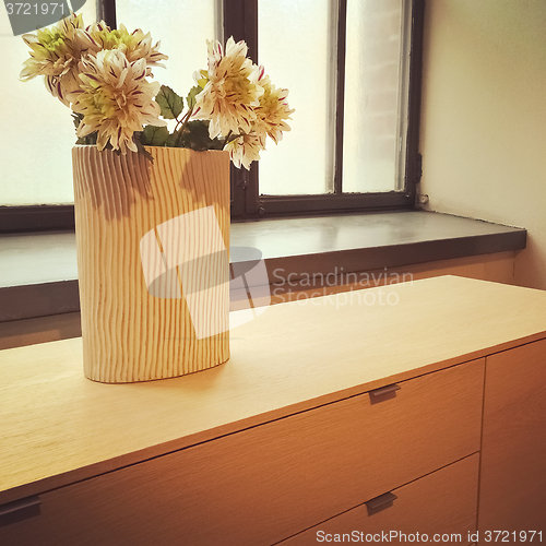 Image of Flowers in a vase decorating a window