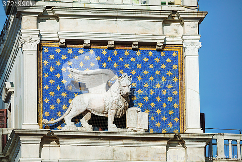 Image of Winged lion on facede of the bell tower at San Marco square in V