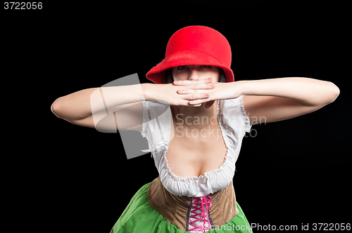 Image of German pretty girl with red hat covers mouth