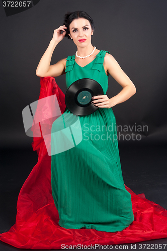 Image of Pretty girl holding vinyl disc