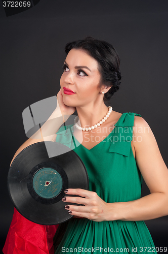 Image of Pretty girl holding vinyl disc
