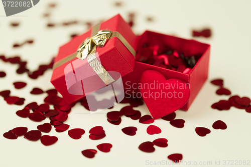 Image of Red hearts confetti on wooden background