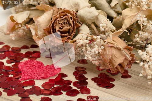 Image of bouquet of dried roses and red box, valentine