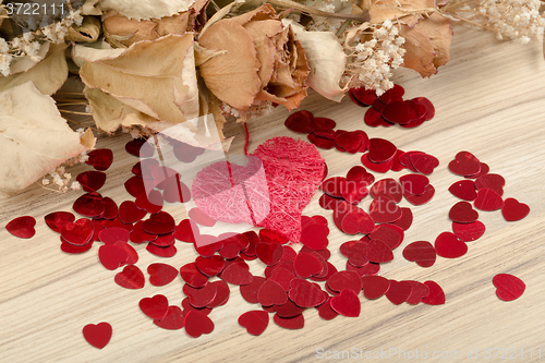 Image of bouquet of dried roses and red box, valentine