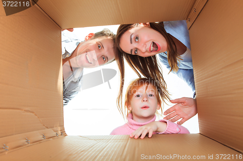 Image of Family in a cardboard box ready for moving house