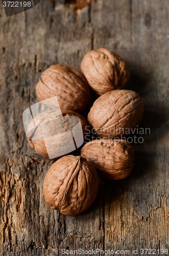 Image of whole walnuts on wooden table