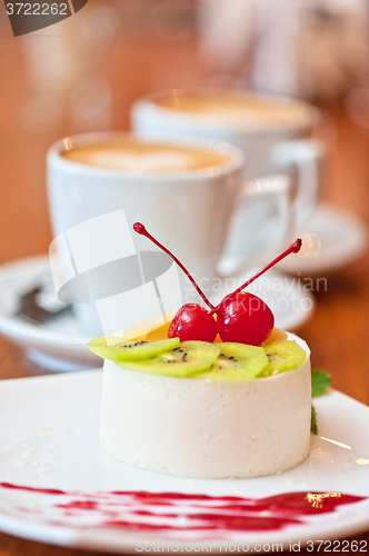 Image of tasty fruit dessert with cherry and kiwi