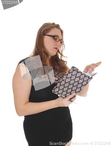 Image of Woman reading in her journal.