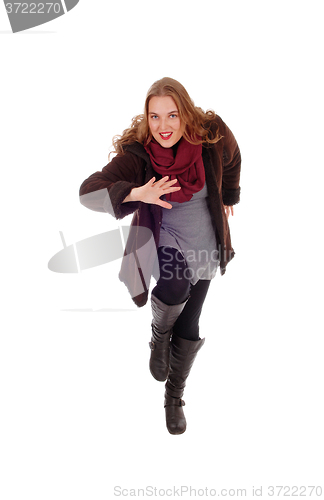Image of Dancing woman in winter coat.