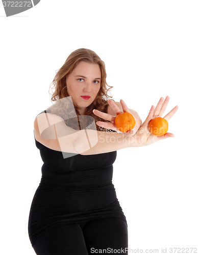 Image of Woman holding two oranges.