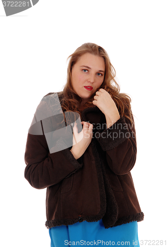 Image of Pretty woman in a brown winter jacked.
