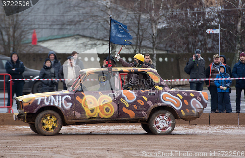 Image of Rust old car with flag