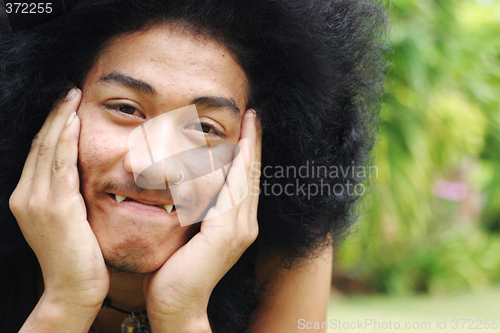 Image of Thai man with a big afro hairstyle.