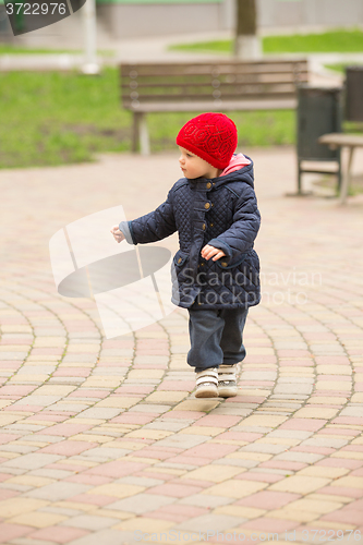 Image of happy child walking in the park