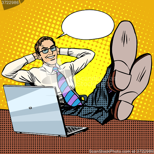 Image of Happy relax businessman at work place near laptop