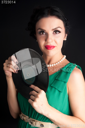 Image of Pretty girl holding vinyl disc