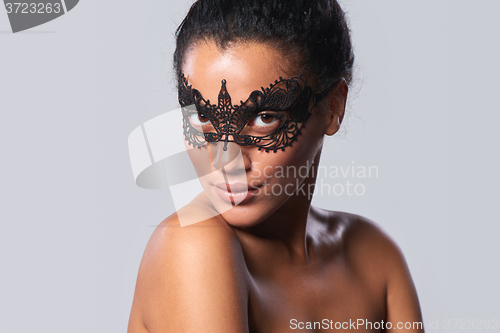 Image of Closeup portrait of beautiful mixed race with black lace mask