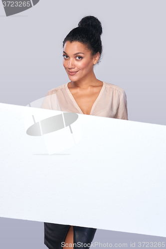 Image of Smiling businesswoman with parcel