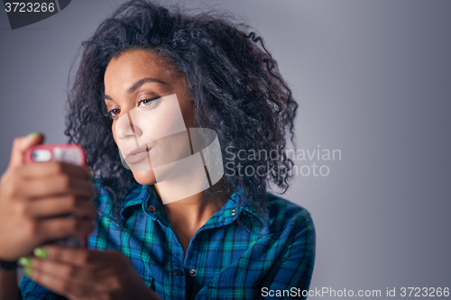 Image of Woman taking self portrait with smart phone