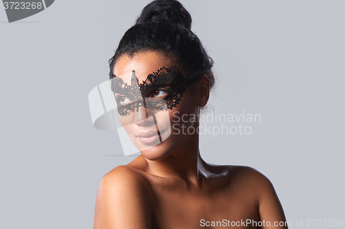 Image of Closeup portrait of beautiful mixed race with black lace mask