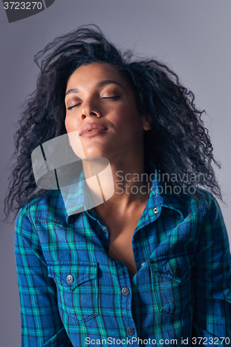 Image of Woman relaxing with closed eyes throwing back