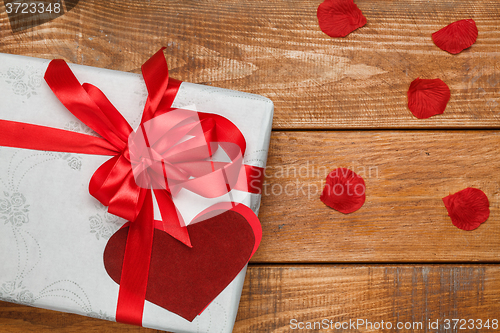 Image of Valentines Day gift and hearts  on wooden background