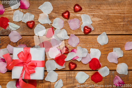 Image of Valentines Day gift and hearts  on wooden background