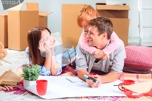 Image of The happy family  during repair and relocation