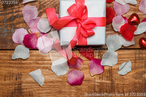 Image of Valentines Day gift and hearts  on wooden background