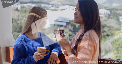 Image of Young women chatting on an open-air patio