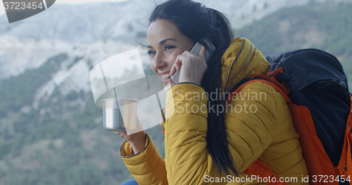 Image of Happy female hiker on phone