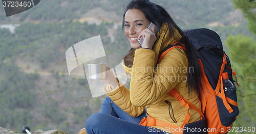 Image of Happy female hiker on phone