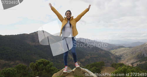 Image of Female hiker rejoicing in the mountains