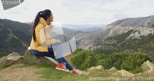 Image of Calm woman looking into valley