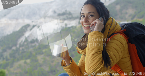 Image of Hiker talking on phone during a break