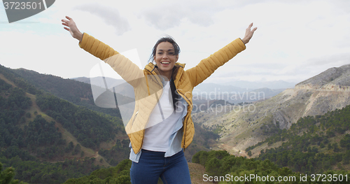 Image of Female hiker rejoicing in the mountains