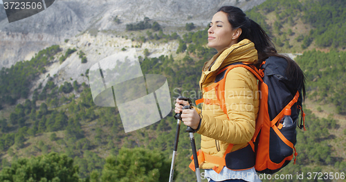 Image of Young woman hiker enjoying the view