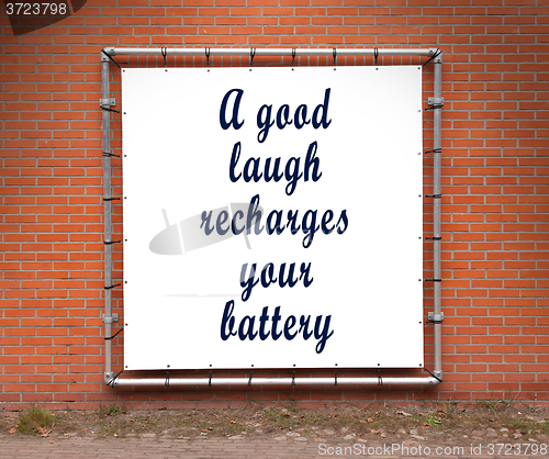 Image of Large banner with inspirational quote on a brick wall