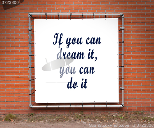 Image of Large banner with inspirational quote on a brick wall