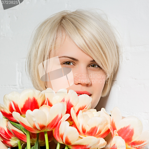 Image of beautiful woman with a bouquet of roses