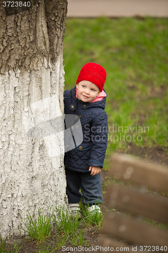 Image of happy child walking in the park