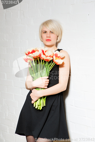 Image of beautiful woman with a bouquet of roses