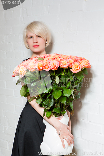 Image of beautiful woman with a bouquet of roses