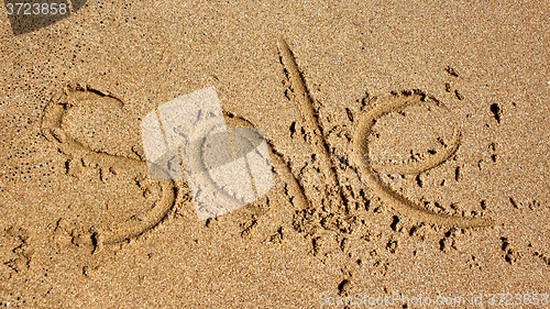 Image of Word sale handwritten in sand