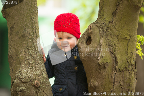 Image of happy child walking in the park