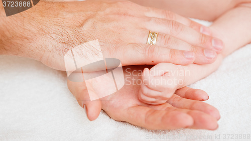 Image of sleeping baby in hand of parent 