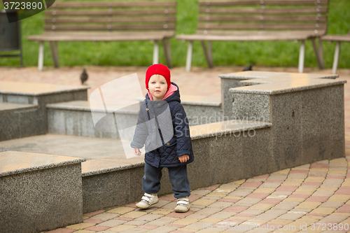 Image of happy child walking in the park