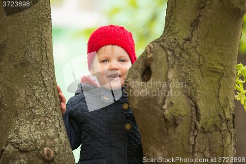 Image of happy child walking in the park
