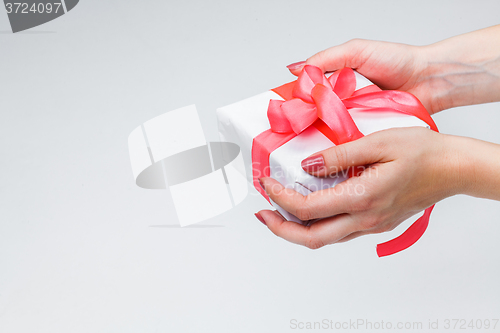 Image of Female hands holding gift box