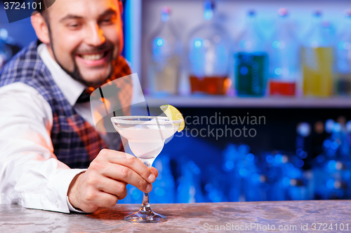 Image of Barman at work, preparing cocktails.